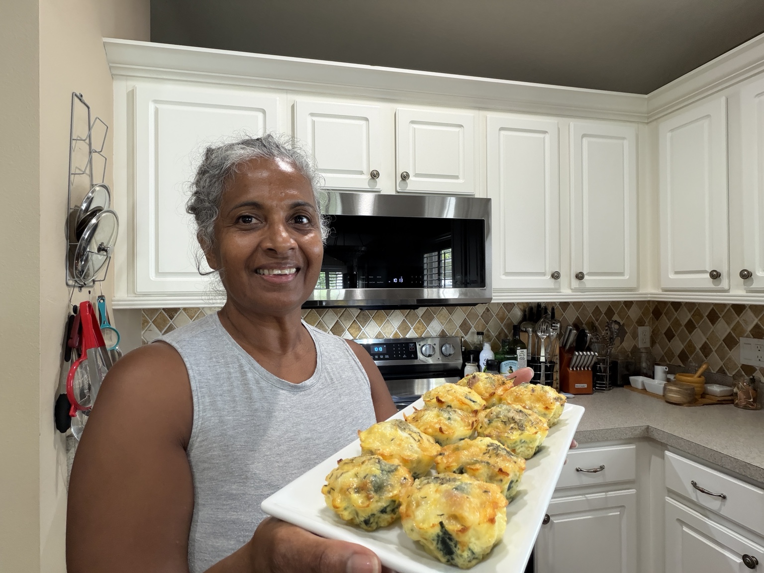 Dianne Morin holding a platter of homemade breakfast egg bites in her kitchen